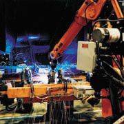 A robotic welding cell at work